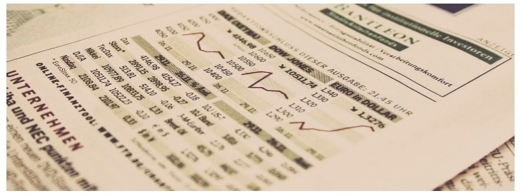 Piece of paper showing stock changes and the price of the Euro compared to dollars.