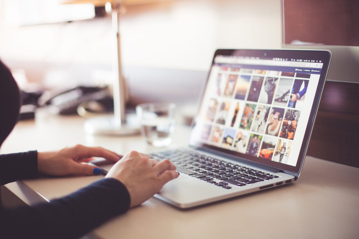 A person looking at pictures on a laptop computer