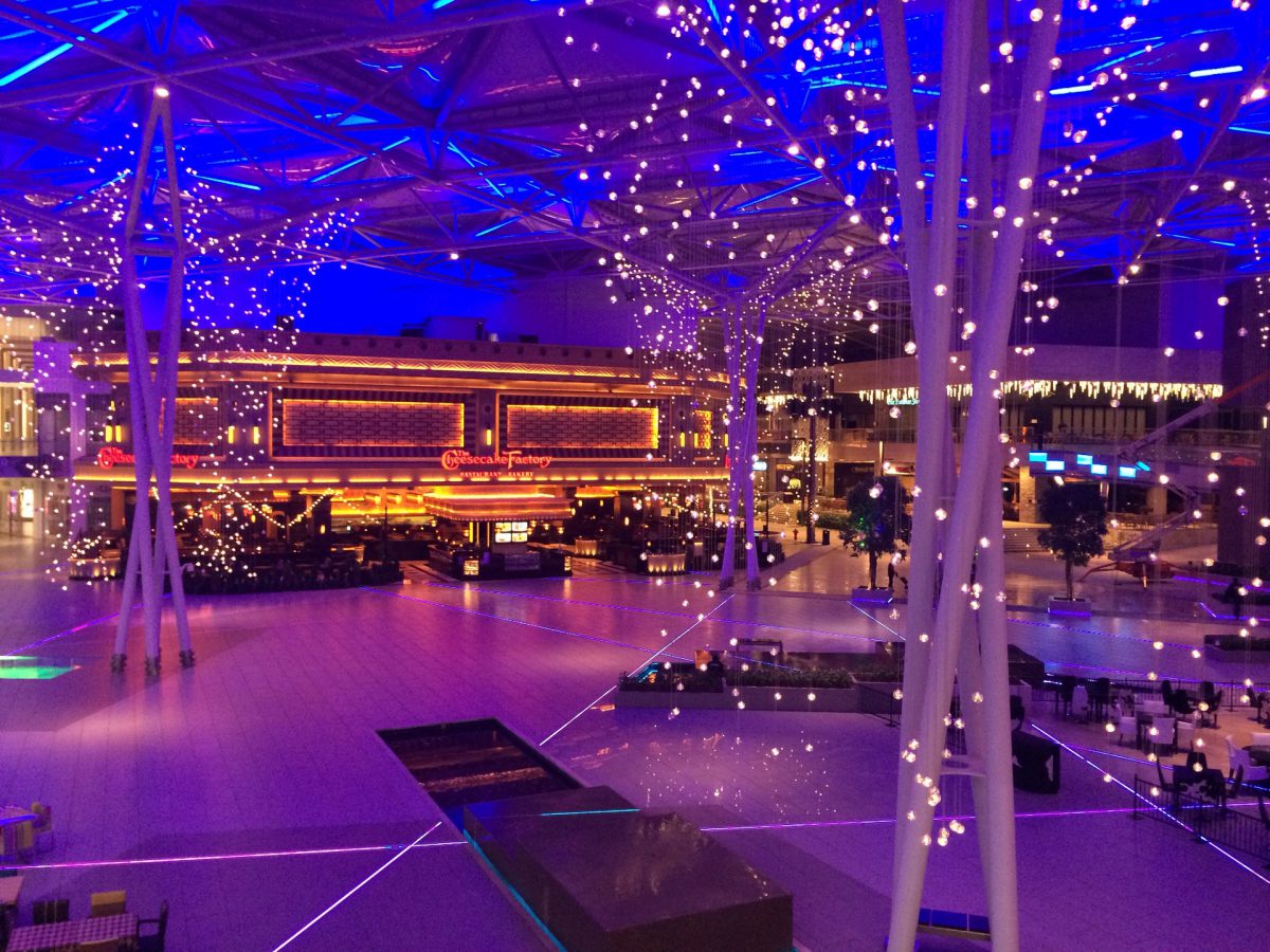 A large event space lit with purple and orange lights