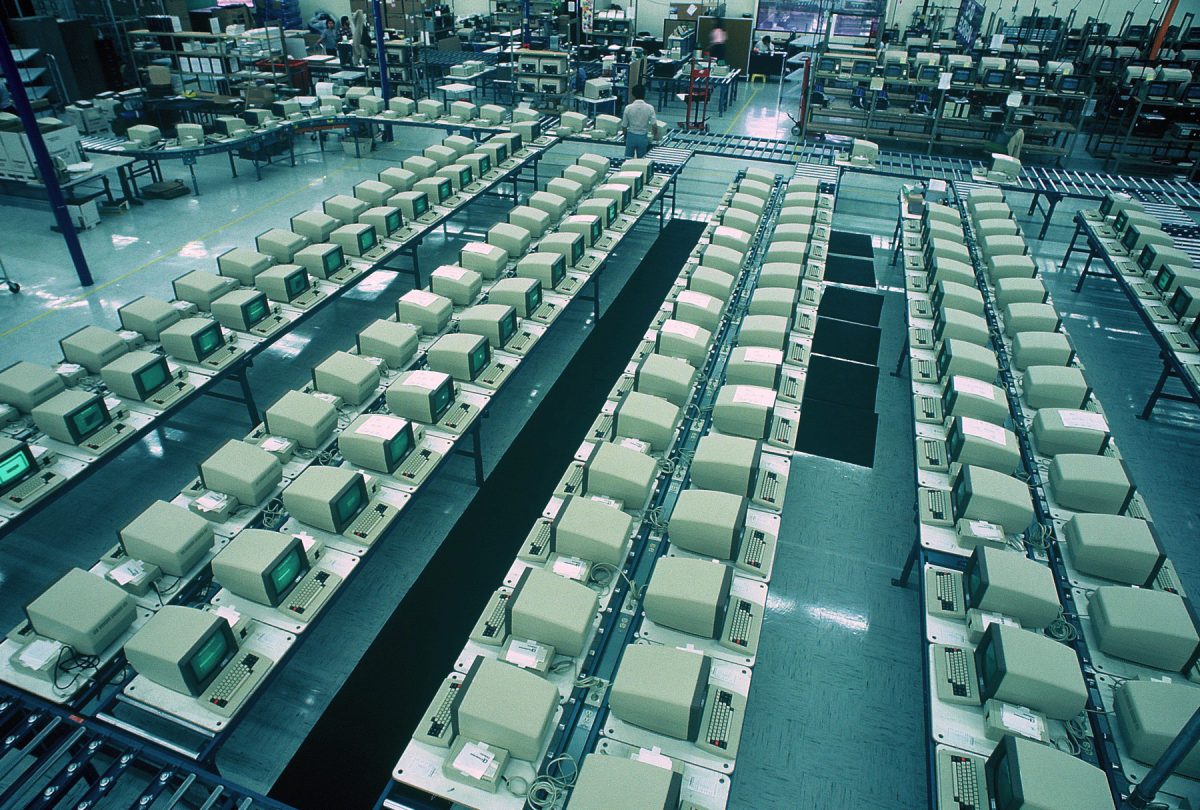 An abstract phot of an office with rows of old fashioned computers