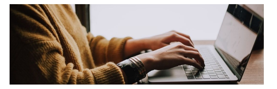 A person typing on a laptop