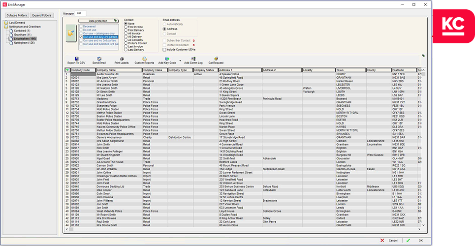 smiling worker looking over data spreadsheet