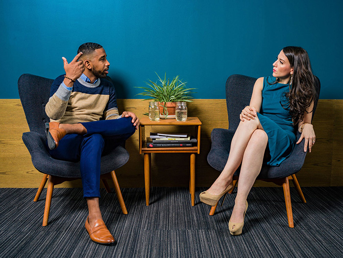 Two people sat beside each other having a conversation