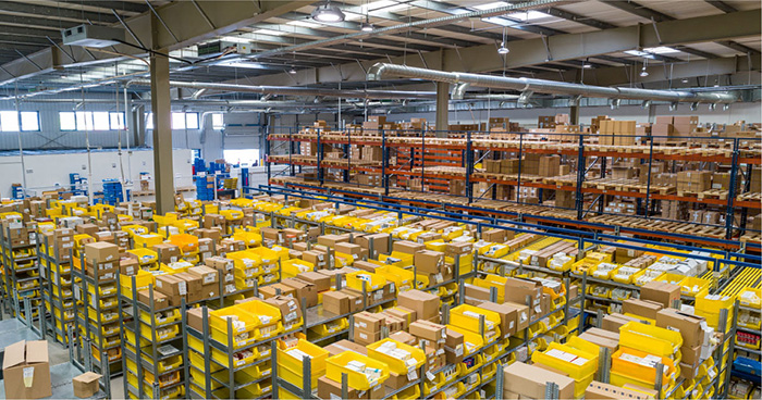 Wide view of a warehouse and loads of racking