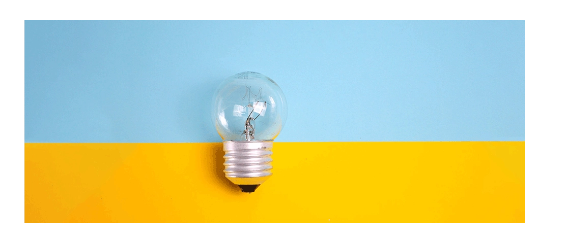 A small lightbulb in front of a blue and yellow background