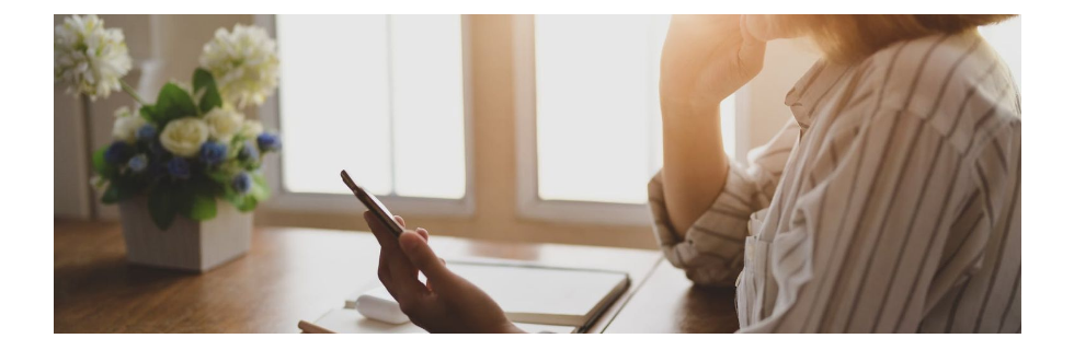 woman at a table on her phone