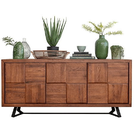 A dresser with various plants in vases on top of it