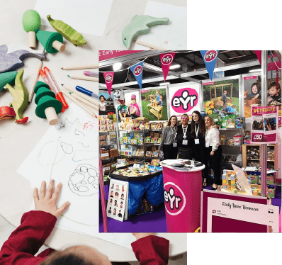 A child drawing on a piece of paper and staff standing at an Early Year Resources trade stand