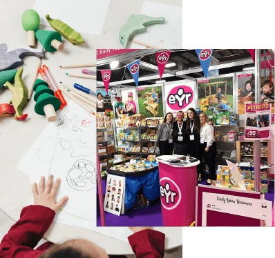 A child drawing on a piece of paper and staff standing at an Early Year Resources trade stand