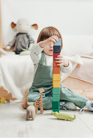 A child stacking colour blocks