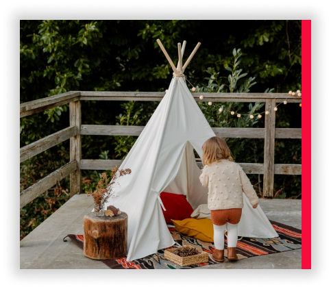 A child looking into the open front of a tent