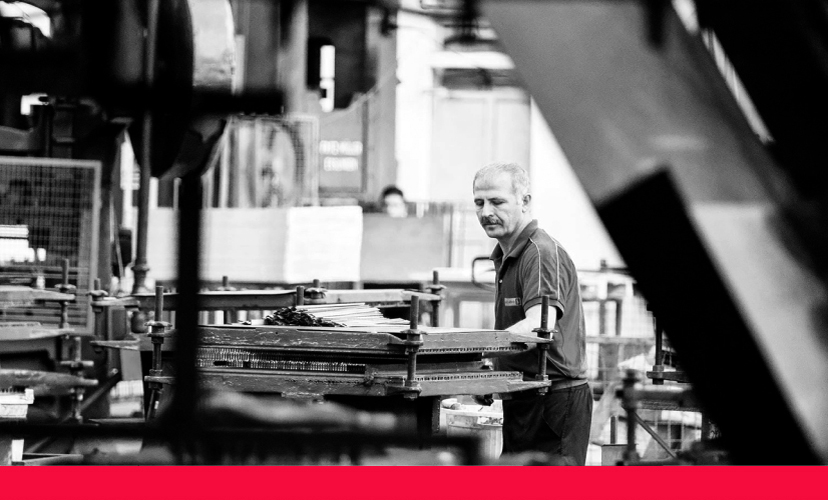 Man working with a machine in a warehouse 