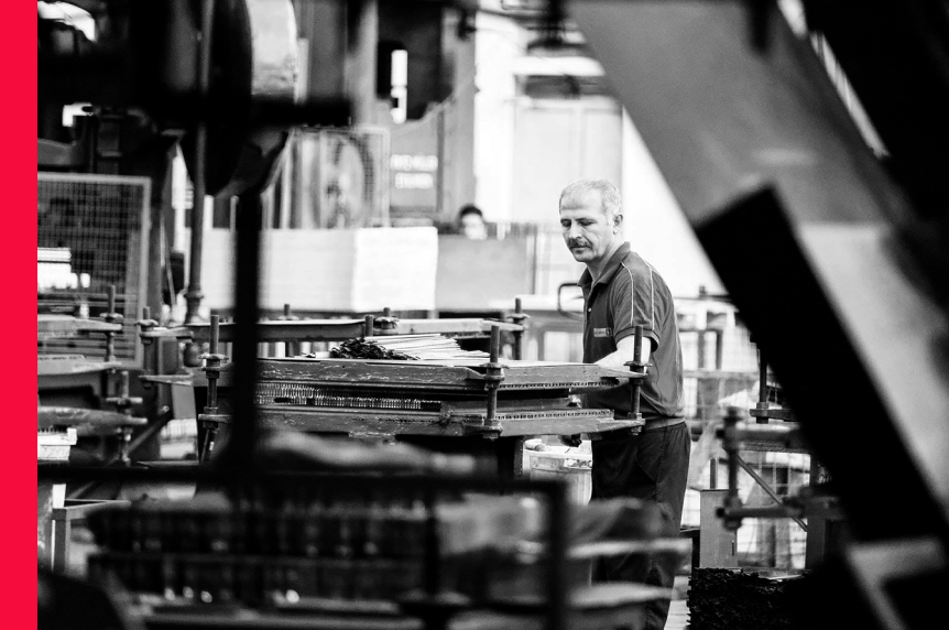 Man working with a machine in a warehouse 