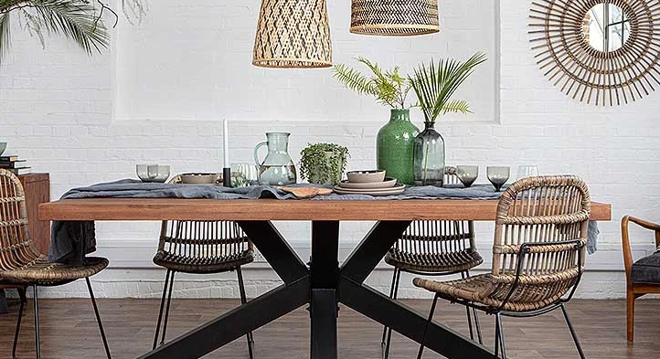 A table with chairs next to it and various glasses and jugs on top of it