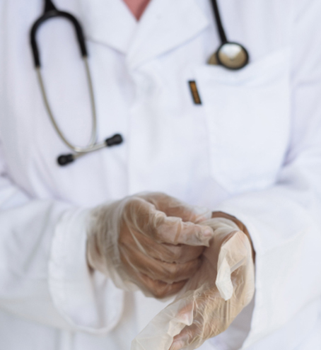 Doctor putting on protective gloves.