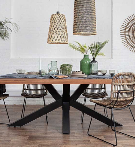 A table with chairs next to it and various glasses and jugs on top of it