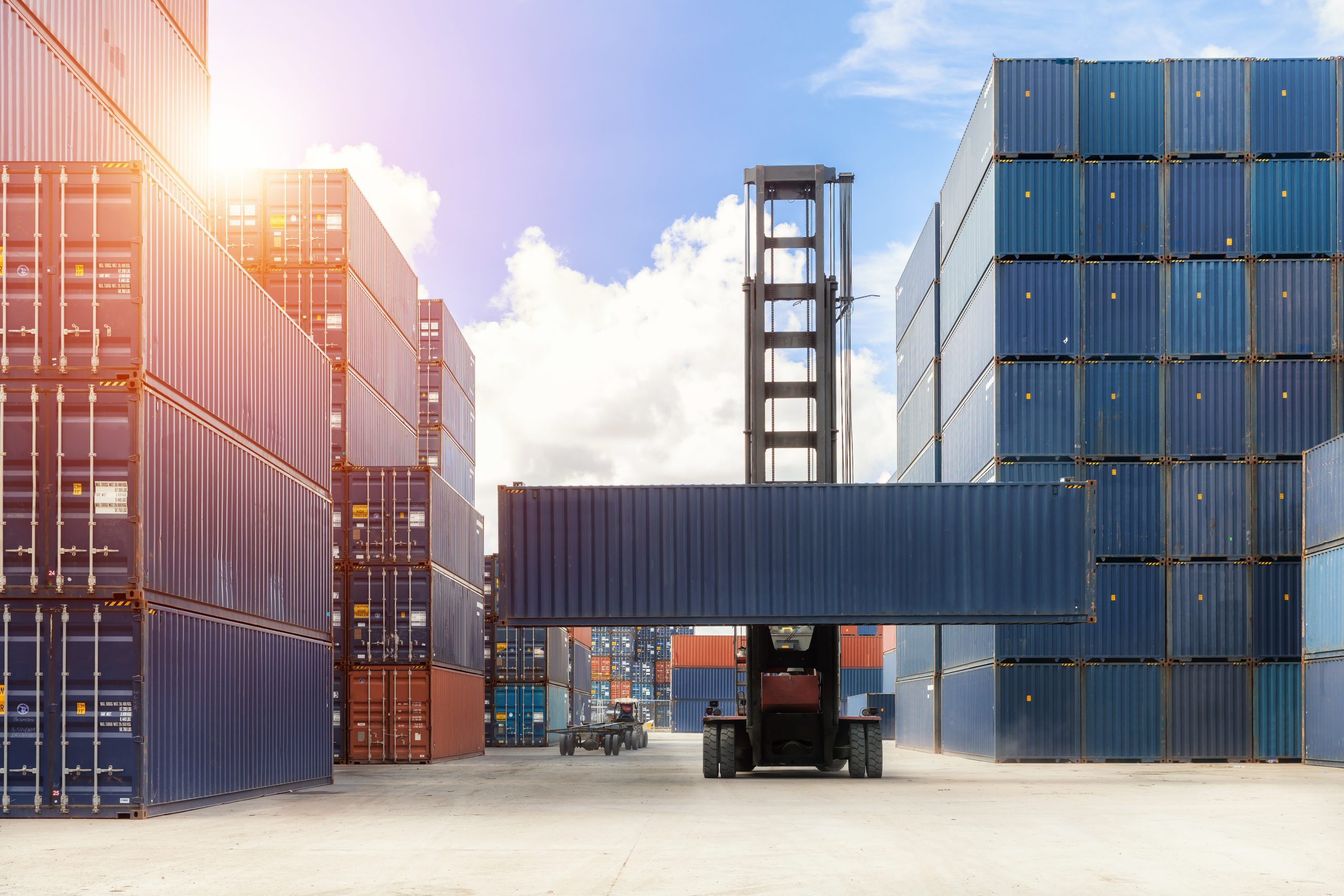 Import, Export, Logistics concept - Crane lift up container box loading to container depot use for cargo import, export, logistics background.