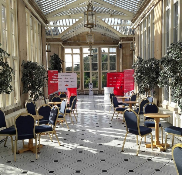 Large conservatory with tables and chairs set out