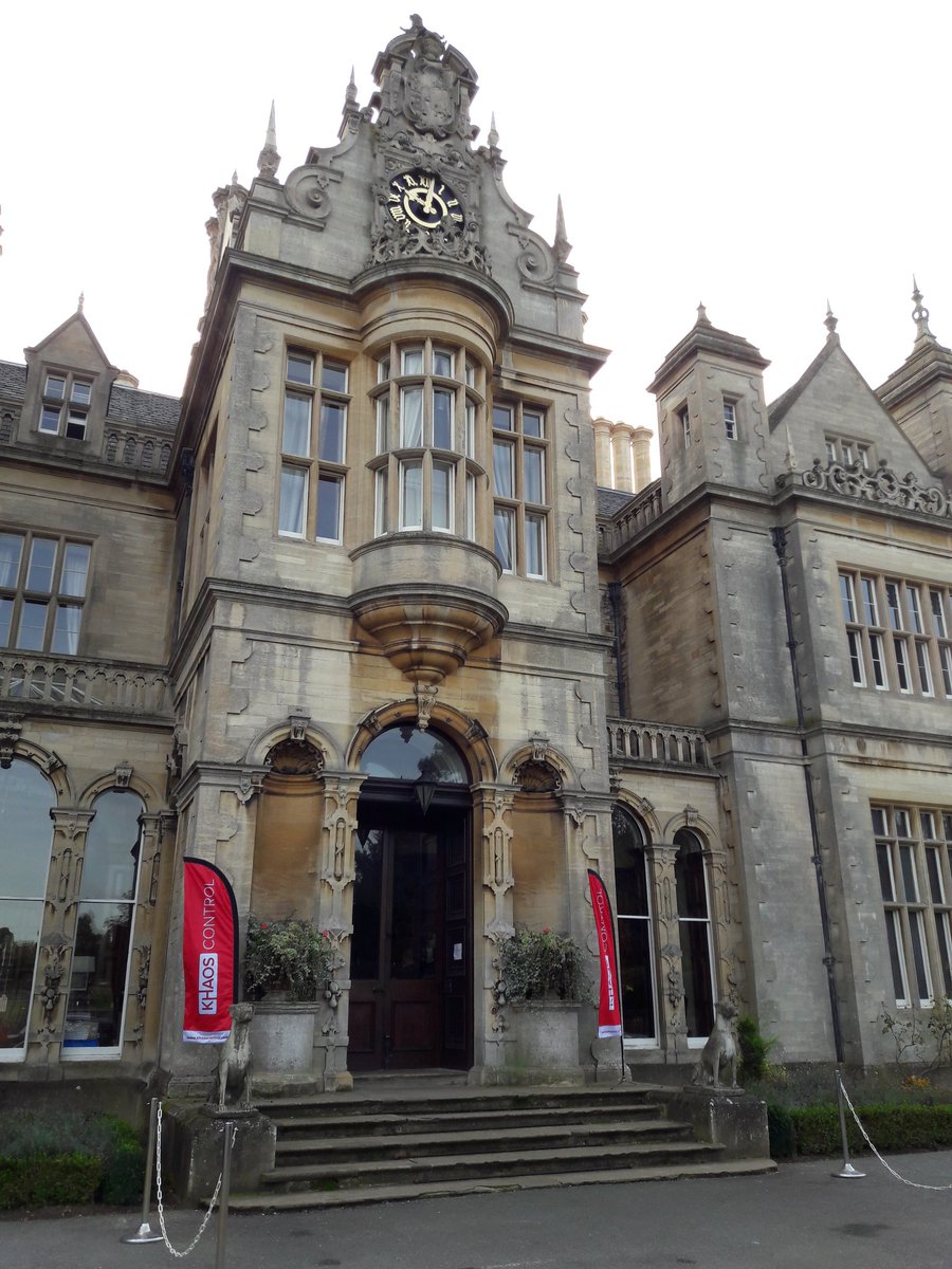 Front of a big hall with a couple of red flags out of the front